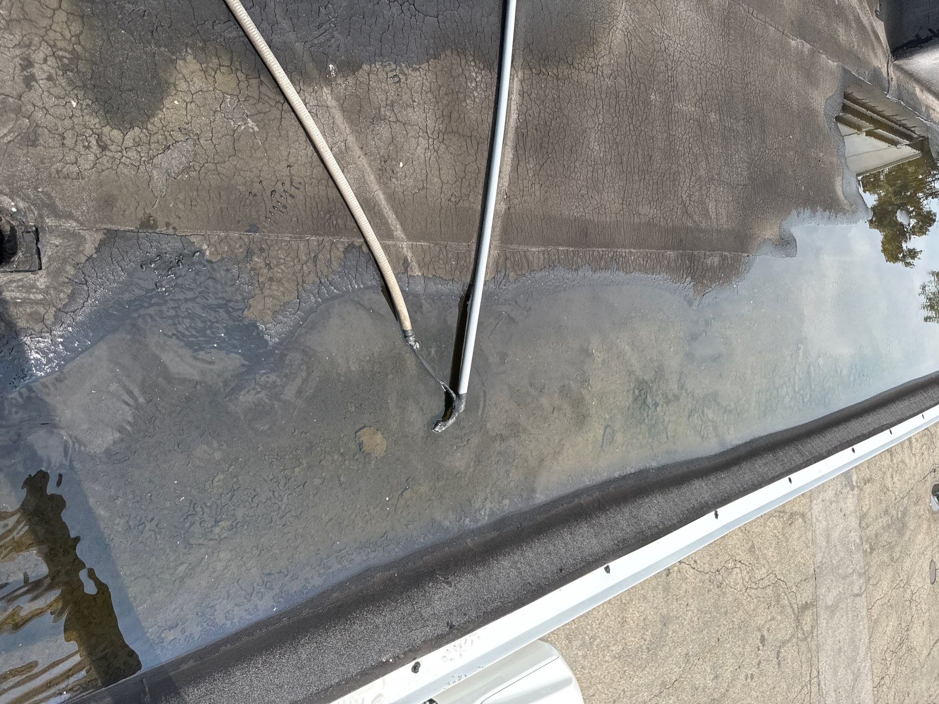 Cracked, ponding roof membrane at a Philadelphia-area car wash.