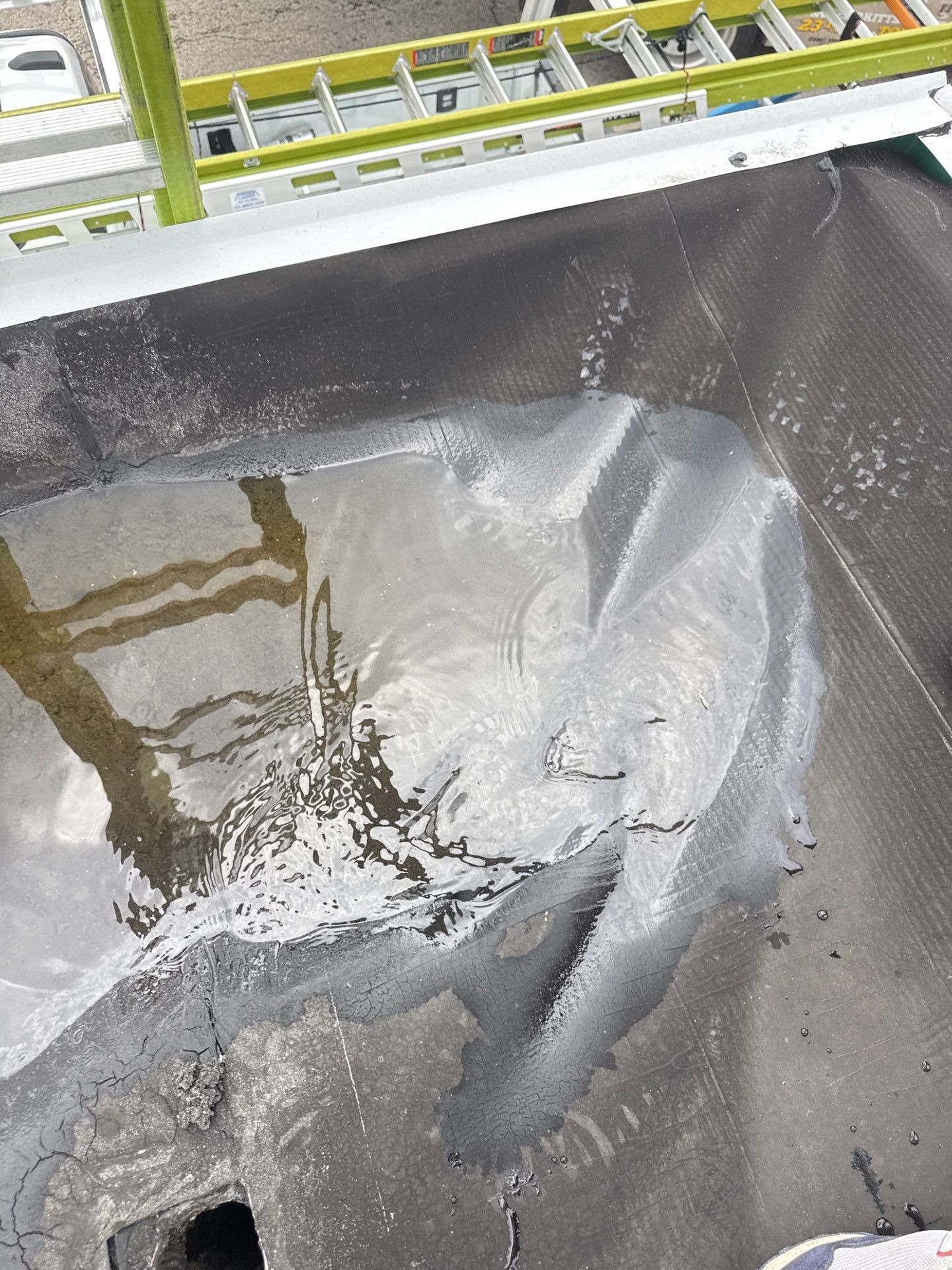 Close-up of deep standing water on the roof membrane.